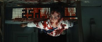Movie still from “Daniel Isn't Real” (2019), directed by Adam Egypt Mortimer – A man with blood all over his face and chest; Medium shot, Overhead angle