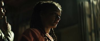 Movie still from “Daniel Isn't Real” (2019), directed by Adam Egypt Mortimer – A woman with dreads is looking to the side; Close Up shot, Low angle