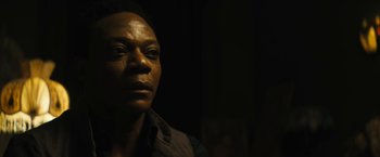 Movie still from “Daniel Isn't Real” (2019), directed by Adam Egypt Mortimer – A person in a dark room; Close Up shot, Low angle