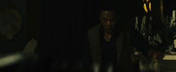 Movie still from “Daniel Isn't Real” (2019), directed by Adam Egypt Mortimer – A man in a black shirt and a black jacket; Close Up shot, Over the shoulder angle