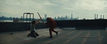 Movie still from “Daniel Isn't Real” (2019), directed by Adam Egypt Mortimer – Two people are fighting on the roof of a building; Wide shot, Over the shoulder angle
