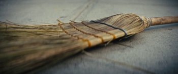 Movie still from “Daniel Isn't Real” (2019), directed by Adam Egypt Mortimer – View of a wooden broom; Extreme Close Up shot, Low angle