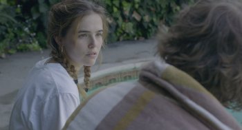Movie still from “Flower” (2017), directed by Max Winkler – A young woman with braids looking at a man; Close Up shot, Over the shoulder angle