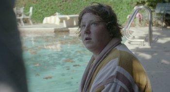 Movie still from “Flower” (2017), directed by Max Winkler – A person standing in front of a swimming pool; Close Up shot, Over the shoulder angle