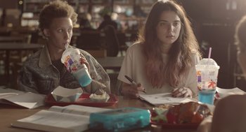Movie still from “Flower” (2017), directed by Max Winkler – Two women sitting at a table with a drink and a sandwich; Medium shot, Over the shoulder angle