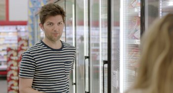 Movie still from “Flower” (2017), directed by Max Winkler – A man standing in front of a refrigerator; Medium shot, Over the shoulder angle