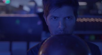 Movie still from “Flower” (2017), directed by Max Winkler – A person holding a bowling ball; Close Up shot, Over the shoulder angle
