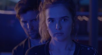 Movie still from “Flower” (2017), directed by Max Winkler – A young woman and a young man in a dark room; Close Up shot, Over the shoulder angle