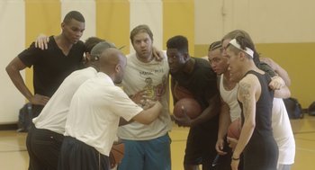 Movie still from “Flower” (2017), directed by Max Winkler – A group of young men standing next to each other on a basketball court; Medium shot, Over the shoulder angle