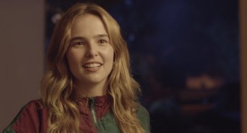 Movie still from “Flower” (2017), directed by Max Winkler – A woman with long blonde hair smiling for the camera; Close Up shot, Over the shoulder angle