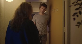 Movie still from “Flower” (2017), directed by Max Winkler – A man and a woman standing in front of a door; Medium shot, Over the shoulder angle