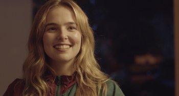 Movie still from “Flower” (2017), directed by Max Winkler – A person with long blonde hair; Close Up shot, Over the shoulder angle