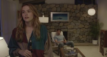 Movie still from “Flower” (2017), directed by Max Winkler – A woman and a man sitting in a living room next to each other; Medium shot, Over the shoulder angle