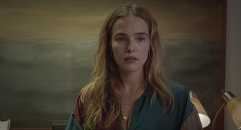 Movie still from “Flower” (2017), directed by Max Winkler – A woman with long blonde hair wearing a colorful shirt; Close Up shot, Over the shoulder angle