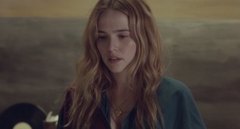 Movie still from “Flower” (2017), directed by Max Winkler – A woman with long blonde hair wearing a blue and red shirt; Close Up shot, Over the shoulder angle