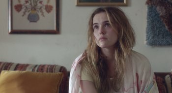 Movie still from “Flower” (2017), directed by Max Winkler – A woman sitting in a living room with her head turned to the side; Close Up shot, Over the shoulder angle
