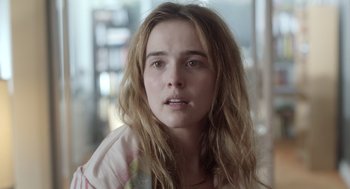 Movie still from “Flower” (2017), directed by Max Winkler – A person with long brown hair; Close Up shot, Over the shoulder angle