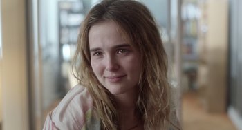 Movie still from “Flower” (2017), directed by Max Winkler – A woman with long hair is posing for a picture; Close Up shot, Over the shoulder angle
