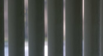 Movie still from “Flower” (2017), directed by Max Winkler – View of a window with vertical blinds; Extreme Close Up shot, Low angle