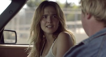 Movie still from “Flower” (2017), directed by Max Winkler – A woman sitting in the back seat of a car crying; Close Up shot, Over the shoulder angle