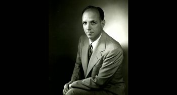 Movie still from “De Palma” (2015), directed by Jake Paltrow – An old photo of a man in a suit and tie; Medium shot, Low angle