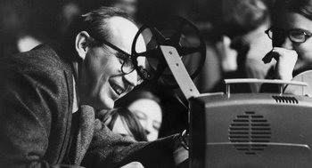 Movie still from “De Palma” (2015), directed by Jake Paltrow – An older man is smiling while watching a movie; Close Up shot, Low angle