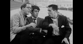 Movie still from “De Palma” (2015), directed by Jake Paltrow – A group of young men sitting next to each other; Medium shot, High angle