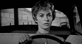 Movie still from “De Palma” (2015), directed by Jake Paltrow – A black - and - white photo of a woman driving a car; Close Up shot, Low angle