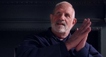 Movie still from “De Palma” (2015), directed by Jake Paltrow – An older man claps his hands in front of a wall; Close Up shot, Low angle