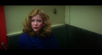 Movie still from “De Palma” (2015), directed by Jake Paltrow – A woman with red hair sitting on a bench; Close Up shot, Low angle