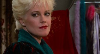 Movie still from “De Palma” (2015), directed by Jake Paltrow – A person with blonde hair wearing a scarf; Close Up shot, Over the shoulder angle