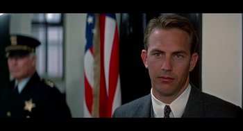 Movie still from “De Palma” (2015), directed by Jake Paltrow – A person wearing a suit and tie; Close Up shot, Low angle