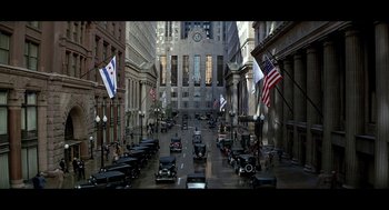 Movie still from “De Palma” (2015), directed by Jake Paltrow – A street filled with lots of cars and flags; Extreme Wide shot, High angle