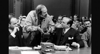 Movie still from “De Palma” (2015), directed by Jake Paltrow – Two men are talking in front of an audience; Medium shot, Over the shoulder angle