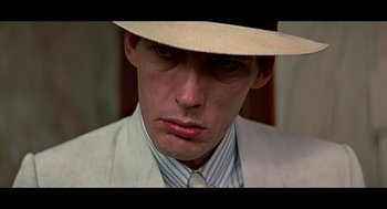 Movie still from “De Palma” (2015), directed by Jake Paltrow – A person wearing a hat and a suit; Close Up shot, Over the shoulder angle