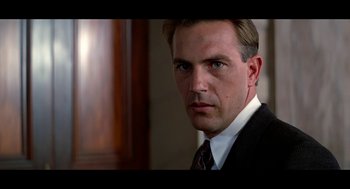 Movie still from “De Palma” (2015), directed by Jake Paltrow – A person wearing a suit and tie; Close Up shot, Low angle