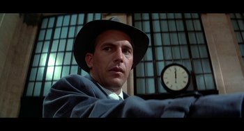 Movie still from “De Palma” (2015), directed by Jake Paltrow – A man wearing a hat and a suit and a clock; Close Up shot, Low angle