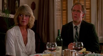 Movie still from “De Palma” (2015), directed by Jake Paltrow – A man and a woman sitting at a dinner table; Medium shot, Low angle
