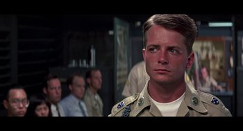 Movie still from “De Palma” (2015), directed by Jake Paltrow – A man in a military uniform standing in front of a group of men; Close Up shot, Over the shoulder angle