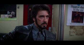 Movie still from “De Palma” (2015), directed by Jake Paltrow – A person wearing a suit and tie; Close Up shot, Over the shoulder angle