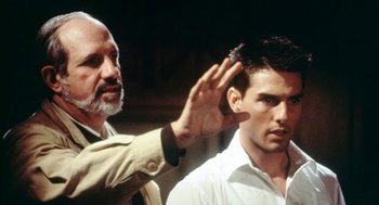 Movie still from “De Palma” (2015), directed by Jake Paltrow – A man standing next to another man in front of a building; Close Up shot, Over the shoulder angle