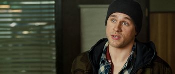 Movie still from “Deadfall” (2012), directed by Stefan Ruzowitzky – A man wearing a hat and a plaid jacket; Close Up shot, Over the shoulder angle