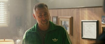 Movie still from “Deadfall” (2012), directed by Stefan Ruzowitzky – A person wearing a green jacket; Close Up shot, Over the shoulder angle