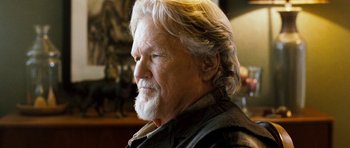 Movie still from “Deadfall” (2012), directed by Stefan Ruzowitzky – An older man with long white hair and a beard; Close Up shot, Low angle