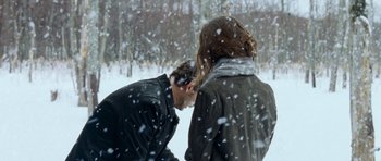 Movie still from “Deadfall” (2012), directed by Stefan Ruzowitzky – A man and a woman standing in the snow; Medium shot, Over the shoulder angle