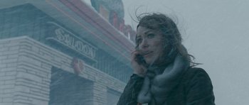 Movie still from “Deadfall” (2012), directed by Stefan Ruzowitzky – A woman on a cell phone in the snow; Close Up shot, Over the shoulder angle