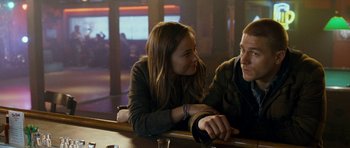 Movie still from “Deadfall” (2012), directed by Stefan Ruzowitzky – A man and a woman sitting at a bar talking to each other; Medium shot, Over the shoulder angle