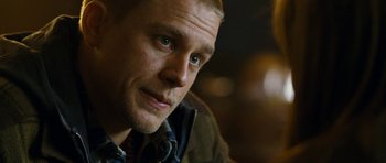 Movie still from “Deadfall” (2012), directed by Stefan Ruzowitzky – A man's face in a dark room; Close Up shot, Over the shoulder angle