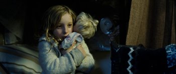 Movie still from “Deadfall” (2012), directed by Stefan Ruzowitzky – A little girl holding a stuffed animal in her arms; Close Up shot, High angle