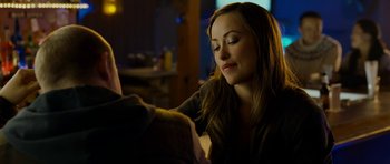 Movie still from “Deadfall” (2012), directed by Stefan Ruzowitzky – A beautiful young lady sitting in front of a man; Close Up shot, Over the shoulder angle